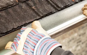 close up shot worker installing gutter guard